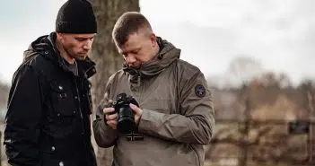 shallow focus photo of man in gray windbreaker hoodie