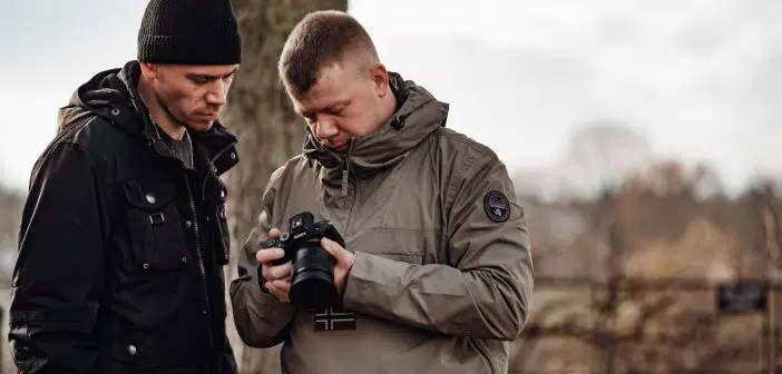 shallow focus photo of man in gray windbreaker hoodie